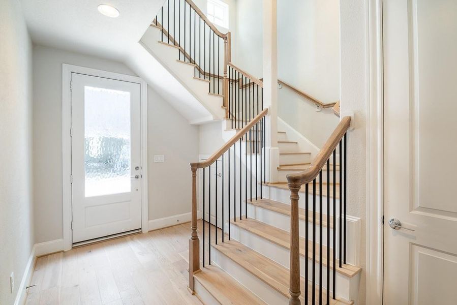 A light and bright entry! Storage under stairs and large hall closet (elevator shaft)