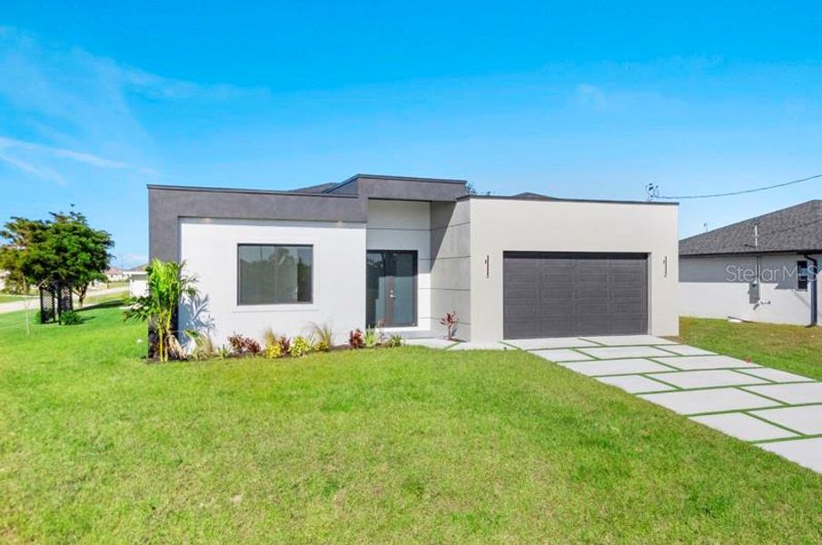 Front exterior of a new home in , Cape Coral, FL, highlighting curb appeal (Image 23).