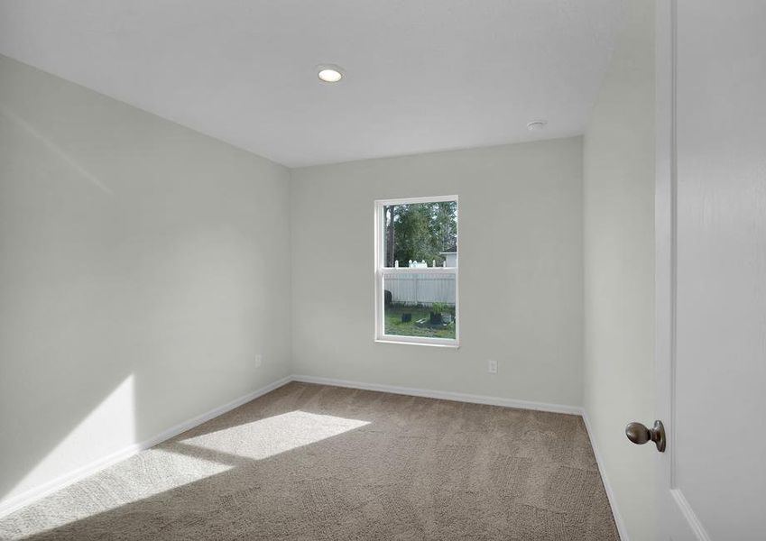 Windows let in plenty of light to this secondary bedroom.