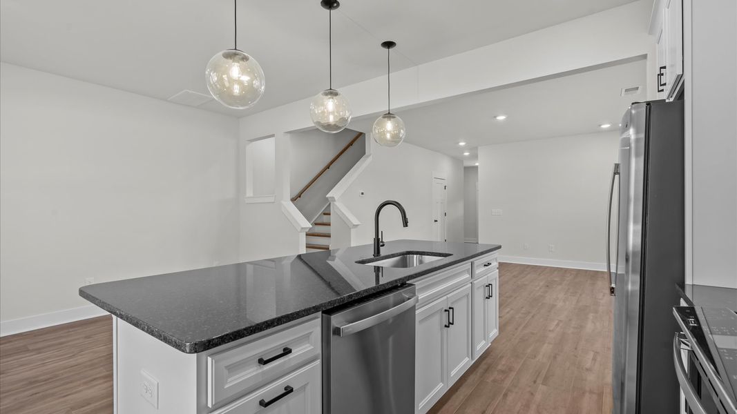 Elegant kitchen featuring a 9-foot island with pendant lighting and tasteful finishes throughout