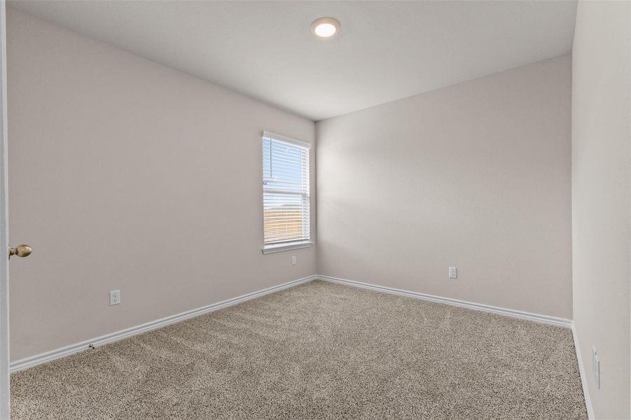 Carpeted empty room featuring baseboards