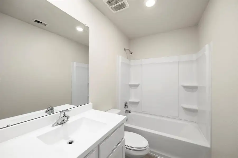 The secondary bathroom, located centrally in the hallway of the home.