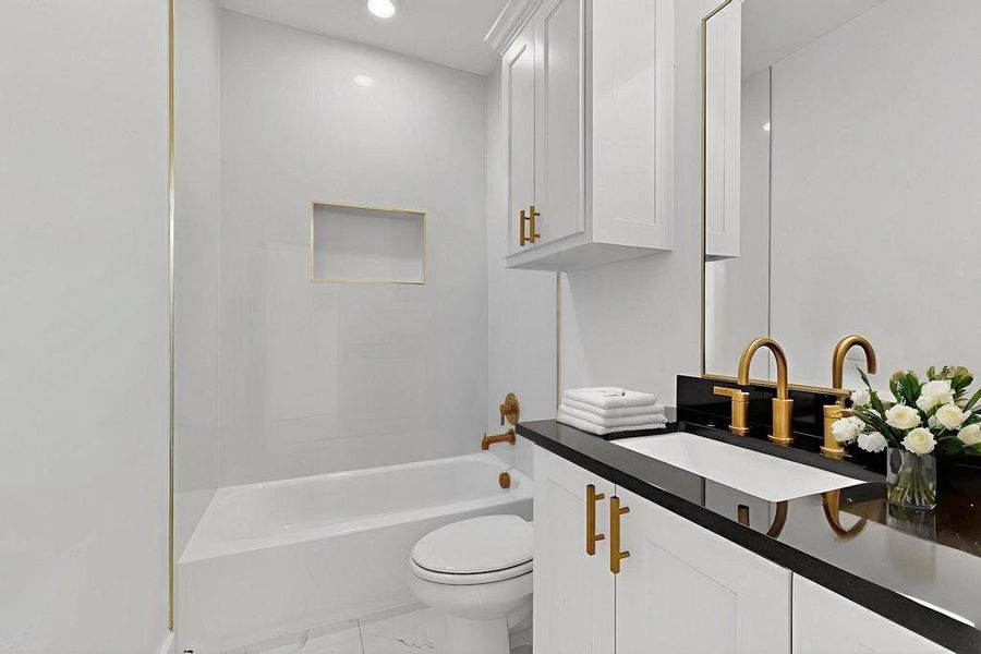 Bathroom featuring vanity, washtub / shower combination, and recessed lighting