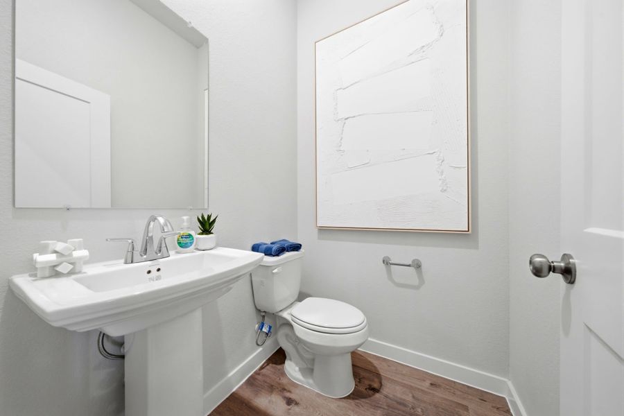 A bathroom with a toilet and sink. A bathroom with a toilet and sink.