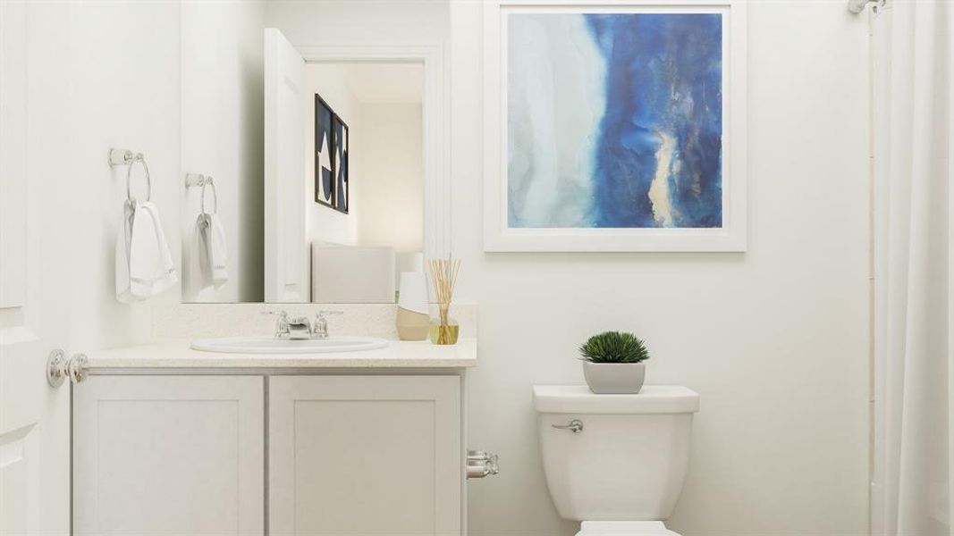 Bathroom featuring vanity and toilet