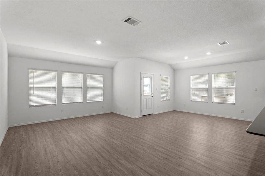 A spacious, airy living area features abundant natural light and modern flooring, ready for personalization. A spacious, airy living area features abundant natural light and modern flooring, ready for personalization.