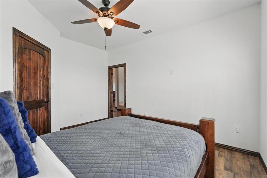 Bedroom with a ceiling fan and wood finished floors Bedroom with a ceiling fan and wood finished floors