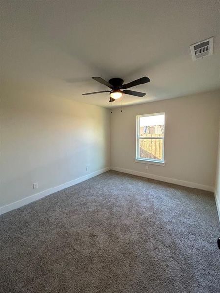 Secondary bedroom (2 of 3) with a ceiling fan