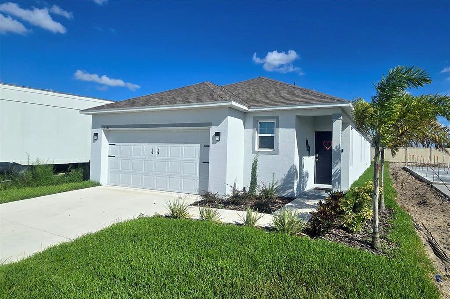 Front exterior of a new home in Hammock Reserve, Haines City, FL, highlighting curb appeal (Image 2). Front exterior of a new home in Hammock Reserve, Haines City, FL, highlighting curb appeal (Image 2).