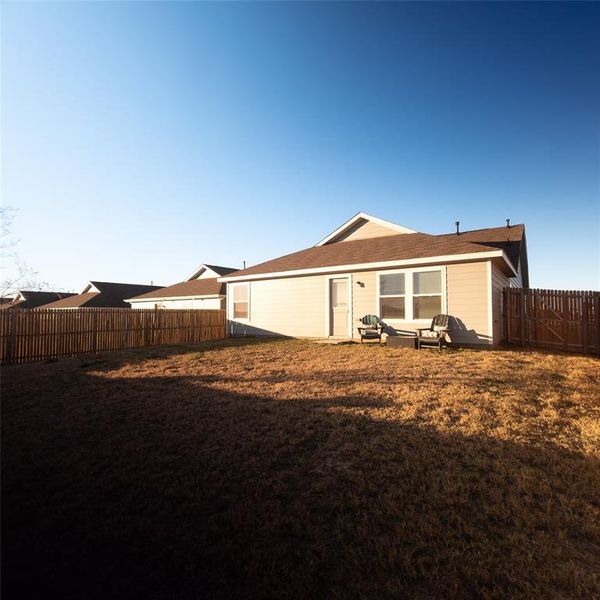 Rear view of house featuring a yard