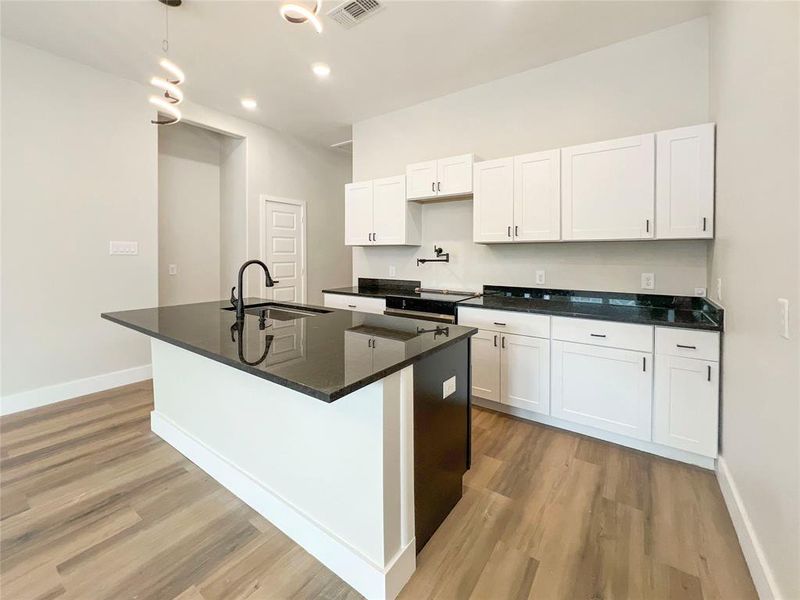 Kitchen featuring light wood-type flooring and a sink