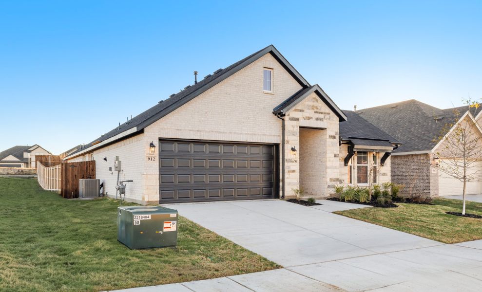 Front exterior of a new home in Elevon, Lavon, TX, highlighting curb appeal (Image 22). Front exterior of a new home in Elevon, Lavon, TX, highlighting curb appeal (Image 22).