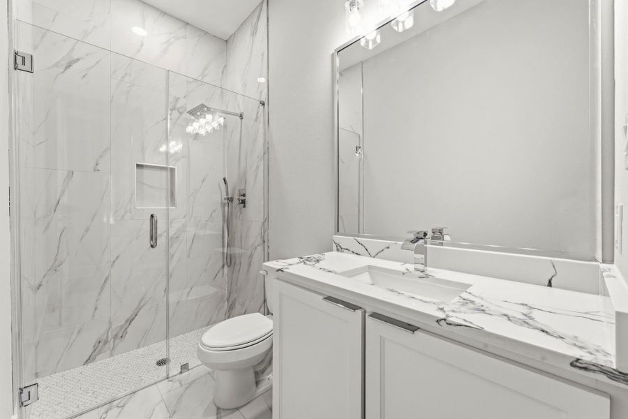 Secondary bathrooms feature quartz countertops, elongated commodes, oversized standing shower.