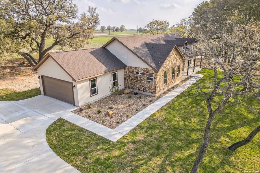 Front exterior of a new home in , Floresville, TX, highlighting curb appeal (Image 2).