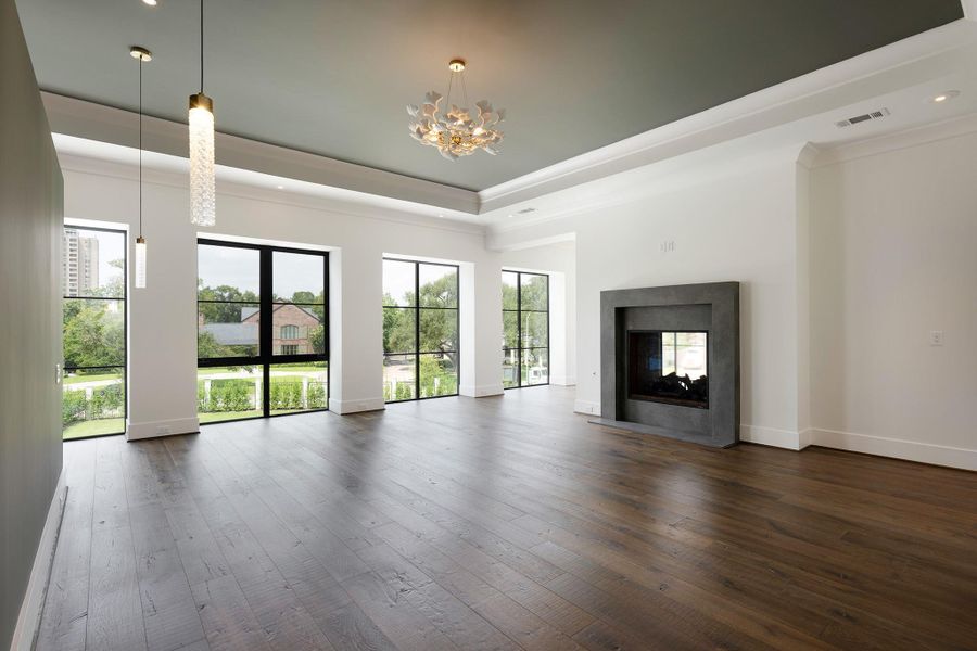 Another view of the spacious primary suite looking towards the front yard and neighborhood.