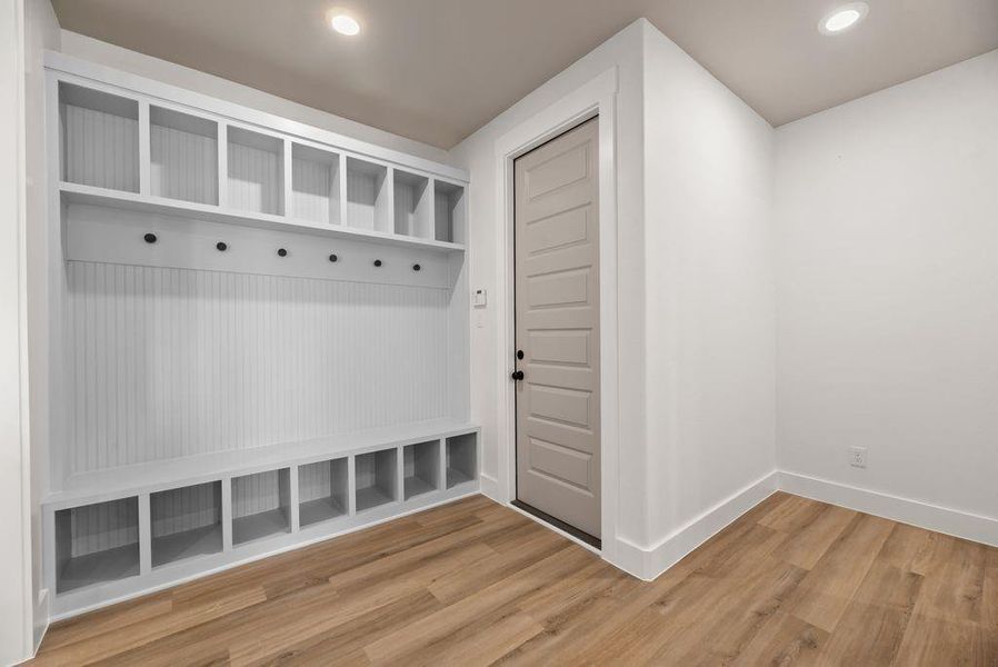 Mudroom with light wood finished floors and recessed lighting Mudroom with light wood finished floors and recessed lighting