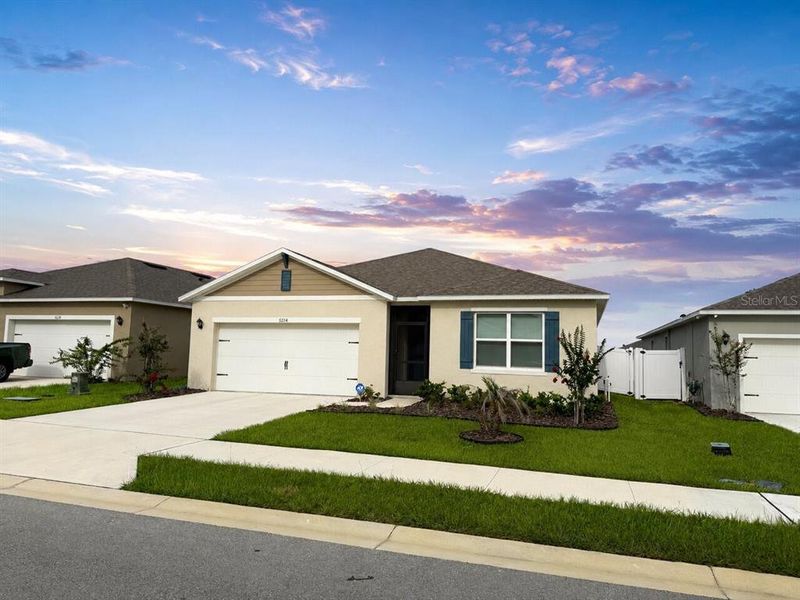 Front exterior of a new home in Wind Meadows South, Bartow, FL, highlighting curb appeal (Image 2). Front exterior of a new home in Wind Meadows South, Bartow, FL, highlighting curb appeal (Image 2).
