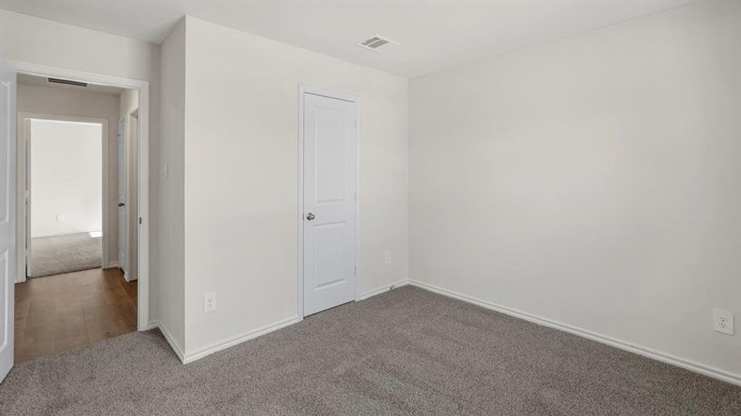 Room featuring light grey carpet, white walls, and white baseboards