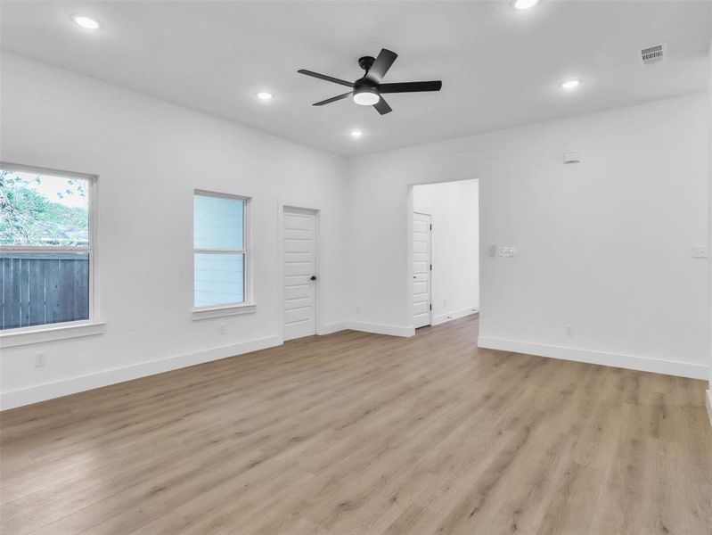 Empty room featuring light wood-style flooring, visible vents, and recessed lighting Empty room featuring light wood-style flooring, visible vents, and recessed lighting