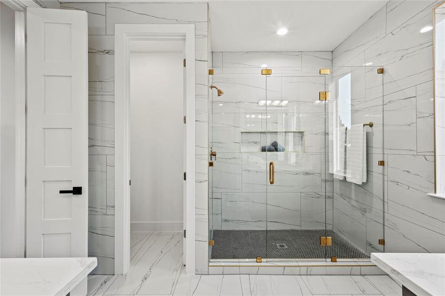 Full bathroom with marble finish floor, a marble finish shower, and vanity