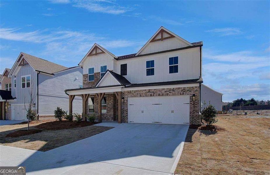 Front exterior of a new home in The Paddocks at Doc Hughes, Buford, GA, highlighting curb appeal (Image 24).