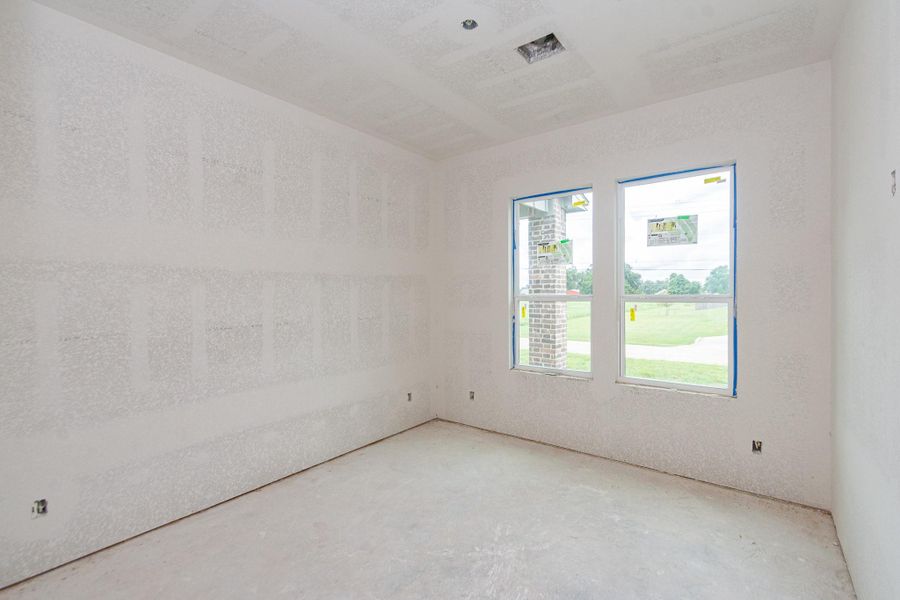 Bright, unfinished room with large windows offering a view of the outdoors, ready for customization to suit your style. Bright, unfinished room with large windows offering a view of the outdoors, ready for customization to suit your style.