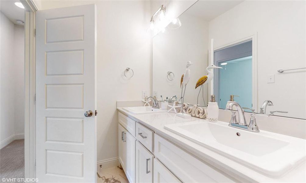 Two sinks and separate water closest/shower room in shared bath upstairs. Sinks will be undercount, not drop in as depicted in rendering.