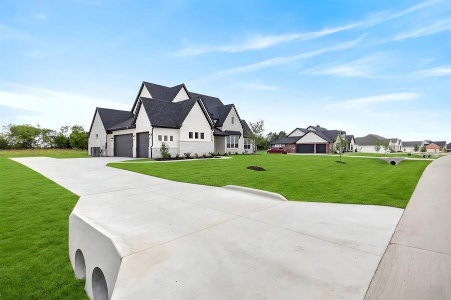 Modern farmhouse-style exterior featuring white siding and dark trim Modern farmhouse-style exterior featuring white siding and dark trim