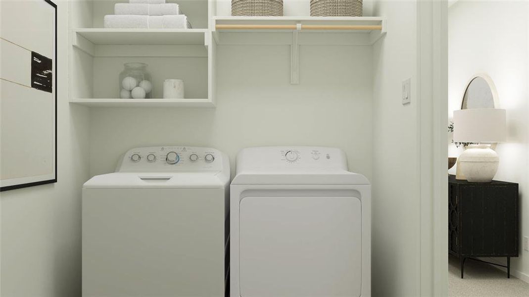 Clothes washing area featuring washer and dryer and carpet flooring