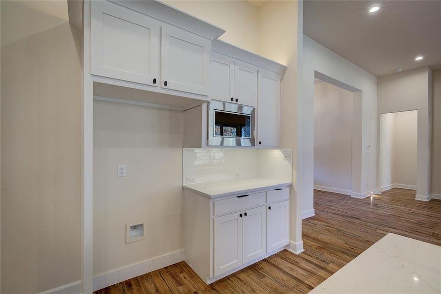 Space for refrigerator and installed microwave.