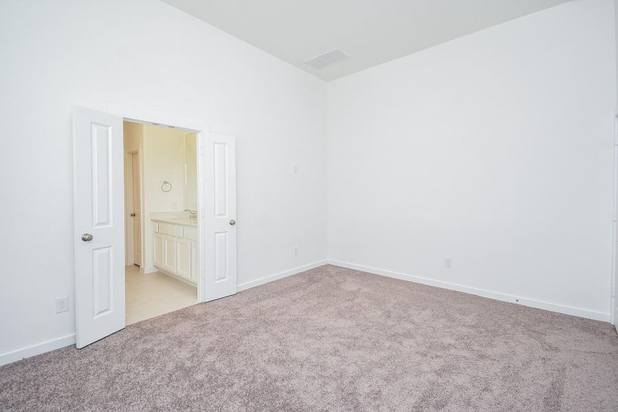 Double doors, left, open onto your primary ensuite bath.