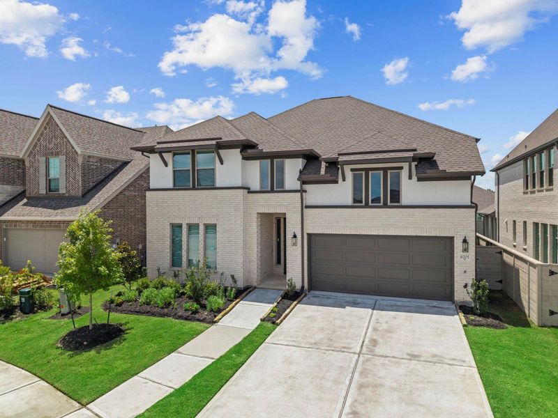 Front exterior of a new home in Legacy, League City, TX, highlighting curb appeal (Image 20). Front exterior of a new home in Legacy, League City, TX, highlighting curb appeal (Image 20).