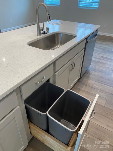 Kitchen Island features Roll out garbage cabinet, single bowl SS sink