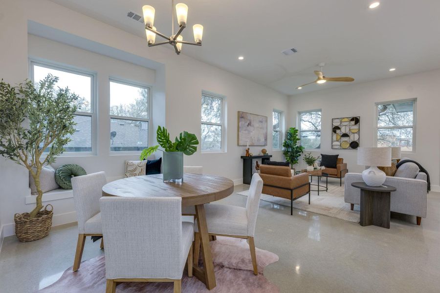 Open family room with windows surrounding to allow in the natural light.