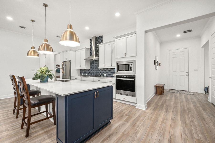 You’ll love the gourmet kitchen and spacious island with quartz counters, pendant lighting, stainless steel appliances, abundant storage, built-ins, and tasteful finishes You’ll love the gourmet kitchen and spacious island with quartz counters, pendant lighting, stainless steel appliances, abundant storage, built-ins, and tasteful finishes