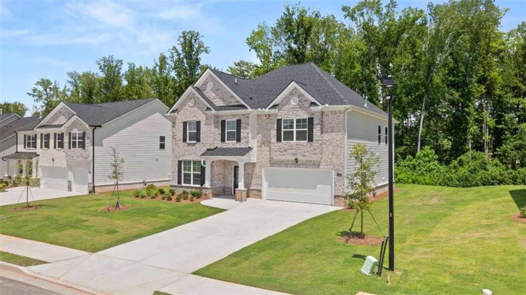 Front exterior of a new home in Independence, Loganville, GA, highlighting curb appeal (Image 1).