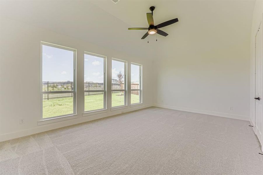 Unfurnished room featuring light carpet and ceiling fan