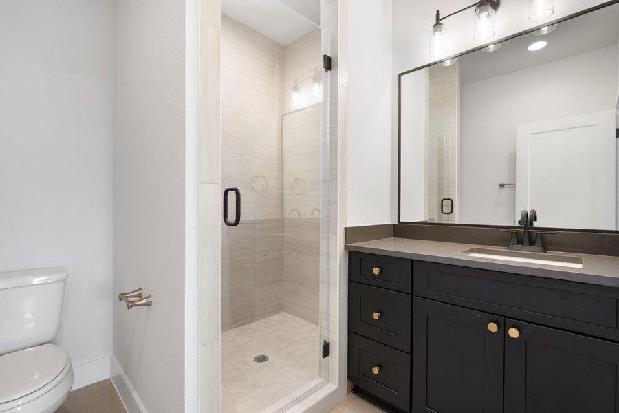 Full bathroom with vanity and a shower stall