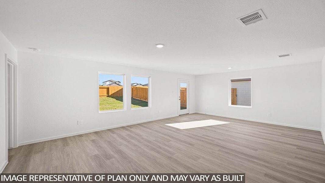 Empty room featuring light wood-type flooring and recessed lighting