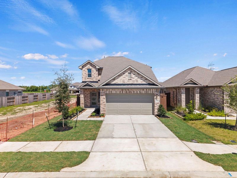 Front exterior of a new home in Creekhaven, Rosharon, TX, highlighting curb appeal (Image 21). Front exterior of a new home in Creekhaven, Rosharon, TX, highlighting curb appeal (Image 21).