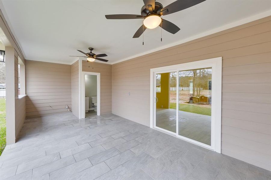 Living room doors open to the backyard, seamlessly blending indoor and outdoor spaces for effortless entertaining and relaxation.