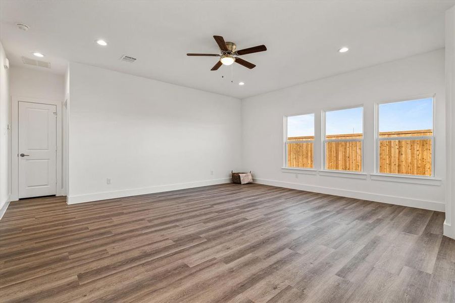 room with ceiling fan and light hardwood / wood-style floors