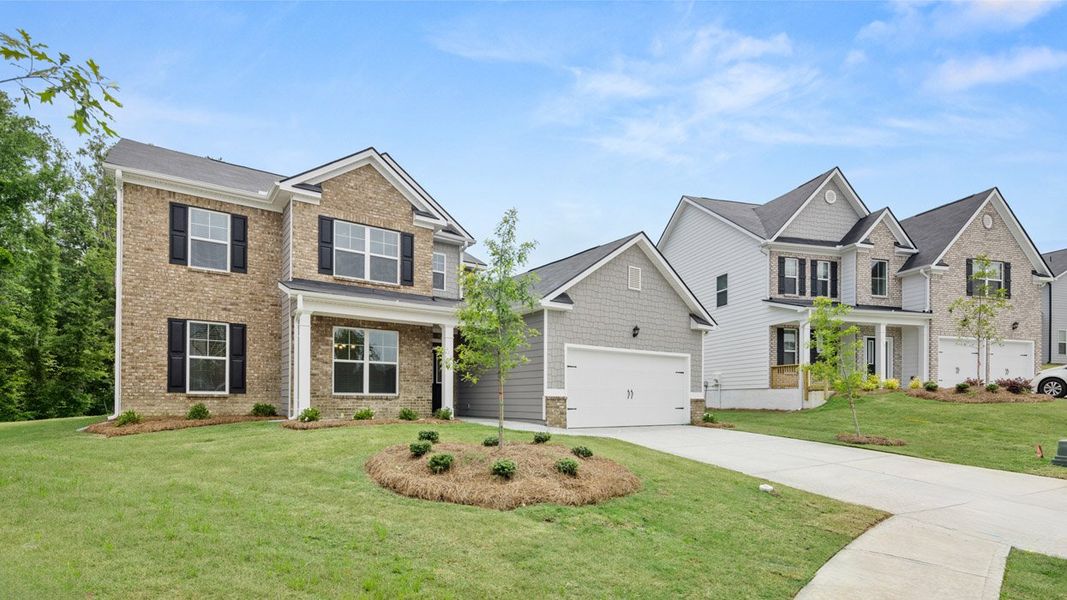 Front exterior of a new home in The Gates at Pates Creek, Hampton, GA, highlighting curb appeal (Image 1). Front exterior of a new home in The Gates at Pates Creek, Hampton, GA, highlighting curb appeal (Image 1).