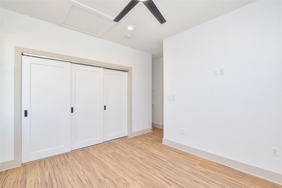 Upstairs primary bedroom . Good closet space, ceiling fans, recessed lighting plus ceiling fan. Prewired for cable & TV electric outlet.