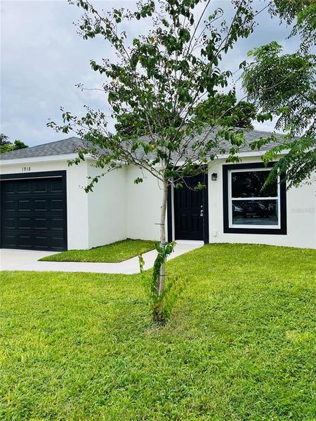 Front exterior of a new home in , Haines City, FL, highlighting curb appeal (Image 2). Front exterior of a new home in , Haines City, FL, highlighting curb appeal (Image 2).