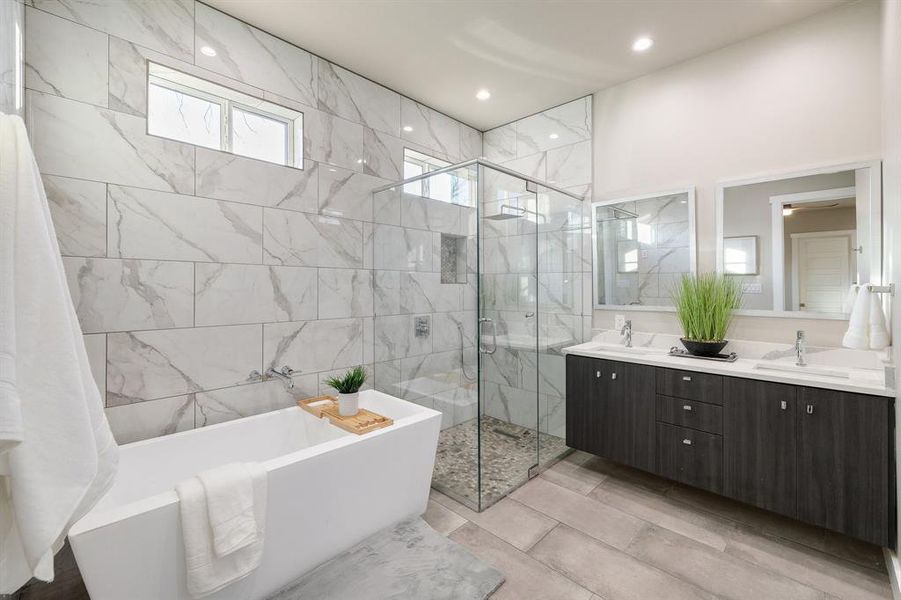 Bathroom featuring independent shower and bath and vanity