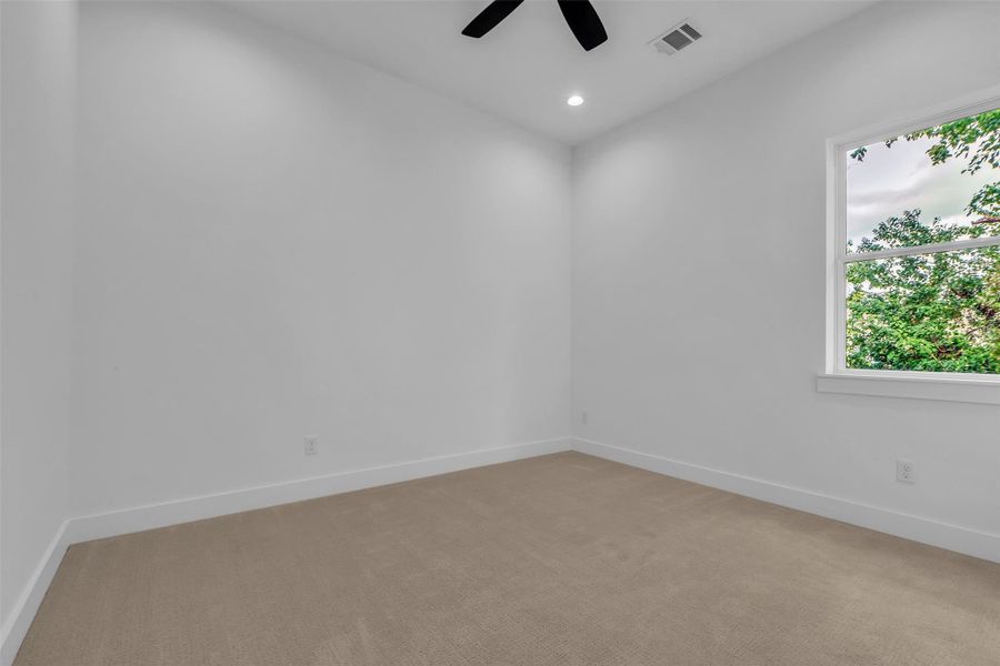 The third-floor secondary bedroom features carpeted flooring and an en-suite bathroom, offering privacy and comfort. The third-floor secondary bedroom features carpeted flooring and an en-suite bathroom, offering privacy and comfort.