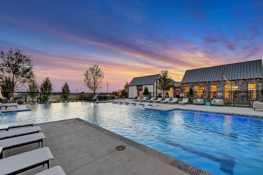 Pool at dusk with a community pool and a patio area Pool at dusk with a community pool and a patio area