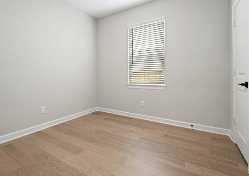 A flex room with a closet and window with faux wood blinds