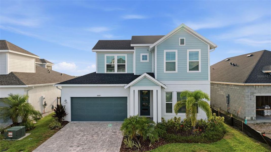Front exterior of a new home in Emerald Landing at Waterside at Lakewood Ranch – Lake Series, Sarasota, FL, highlighting curb appeal (Image 22). Front exterior of a new home in Emerald Landing at Waterside at Lakewood Ranch – Lake Series, Sarasota, FL, highlighting curb appeal (Image 22).